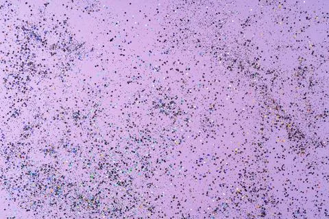 Multicolored sequins on a lilac background . Stock-Fotos