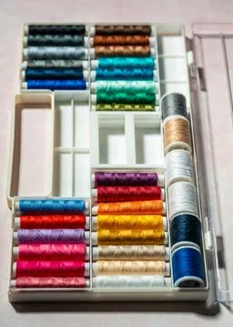 Multicolored sewing thread spools shown in close up, featuring bright tones,  스톡 사진