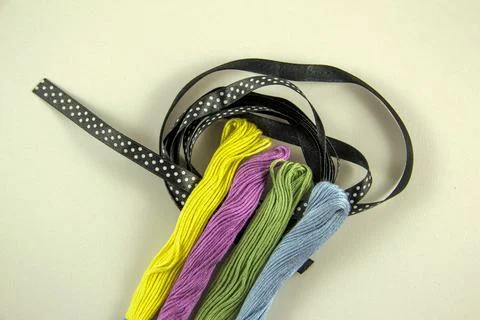 Multicolored sewing threads and black polka dot ribbon Stock Photos