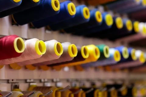 Multicolored sewing threads bobbins on stand Stock Photos