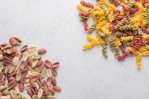 Multicolored shells macaroni background concept. Diet and healthy food concept Foto stock