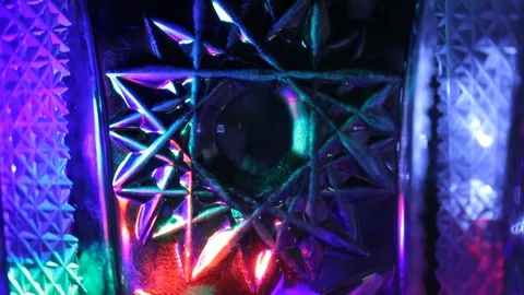 Multicolored shimmer of light rays on a background with different patterns Stock Footage 105941548