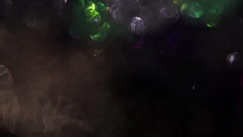 Multicolored shiny bokeh on dark background at night Видео 318365154