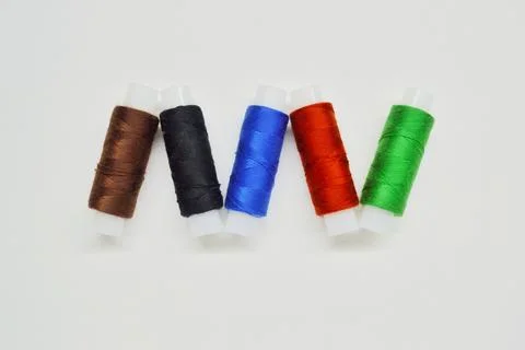 Multicolored skeins of thread on a white background Stock Photos