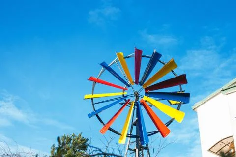 Multicolored small windmill by blue sky Stockfoto's