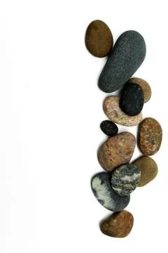 Multicolored smooth pebbles isolated on a white background Stock Photos