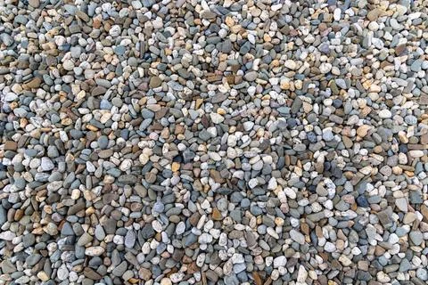 Multicolored Smooth River Pebbles Background. A full frame view of a large Stock Photos