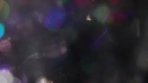 Multicolored sparkling bokeh lights in the dark Stock Footage 318579772