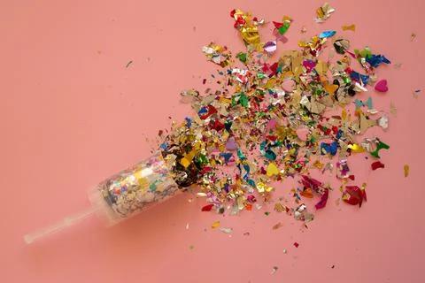 Multicolored sparkling candy on a pink background. Stock Photos