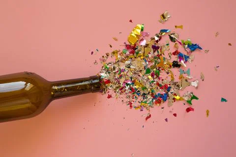 Multicolored sparkling candy on a pink background. Stock Photos
