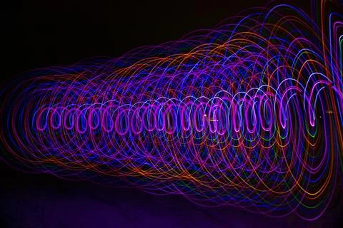Multicolored spiral with light on a dark background. Stock Photos