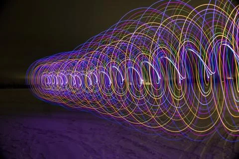 Multicolored spiral with light on a dark background. Stock Photos