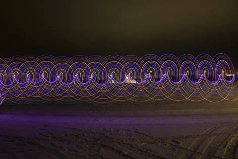 Multicolored spiral with light on a dark background. Stock Photos