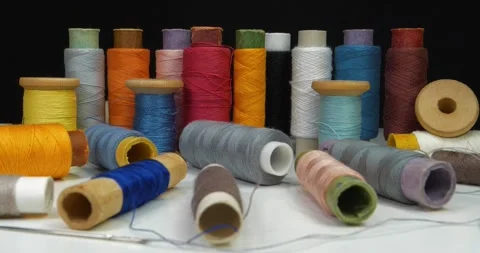 Multicolored spools thread. Spools of multi-colored threads lies on white table Stock Footage 309103546