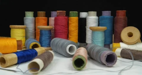 Multicolored spools thread. Spools of multi-colored threads lies on white table Stock Footage 310251122