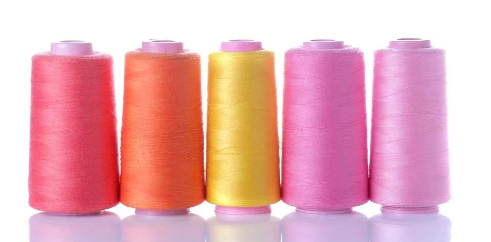 Multicolored spools with threads on white isolated background. accessories fo Stock Photos