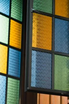 Multicolored stained glass window with rectangular pattern in blue, yellow an Stockfoto's