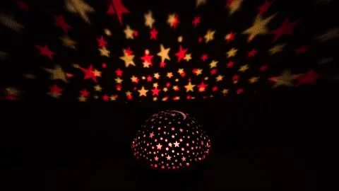 Multicolored stars on the wall from a glowing lantern Stock Footage 230093153