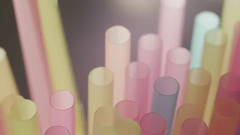 Multicolored straws for drinks, camera movement, against the backdrop of light Stock Footage 153054426