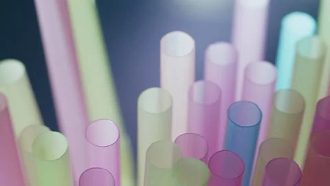 Multicolored straws for drinks, close-up, against the backdrop of light Stock Footage 153632426