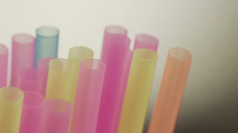 Multicolored straws for drinks, close-up, camera movement Stock Footage 153387543