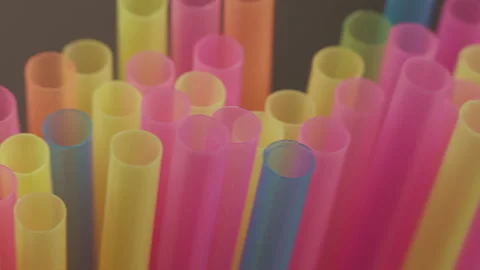 Multicolored straws for drinks, close-up, camera movement, dark background Stock Footage 153868008