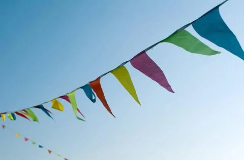 Multicolored striped flags Multicolored striped triangular flags on a rope... Stock Photos
