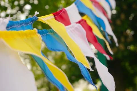 Multicolored striped triangular flags on a two rope, closeup, focus 写真素材