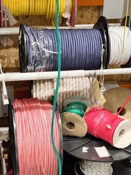 Multicolored strong ropes wound on spools displayed in a hardware store sec.. Stock Photos