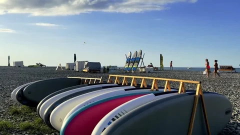 Multicolored SUP boards parked on pebble beach of Batumi Stock Footage 255388440