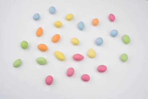 Multicolored sweets scattered on the white table Stock-Fotos
