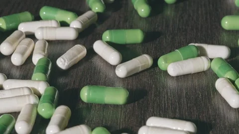 Multicolored tablets are pouring onto the table Stock-Footage 270414202