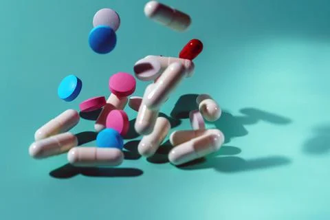 Multicolored tablets levitate on a blue background Stock Photos