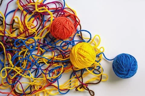 Multicolored tangled threads and winding them into balls. Copy space Stock Photos