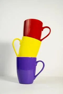Multicolored Tea Cups Arranged Creatively on Minimal white Background Stock-Fotos