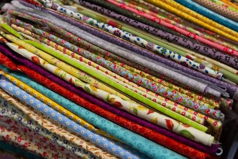 Multicolored textiles on the counter of the store Stock Photos