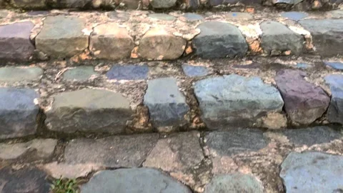 MULTICOLORED  TEXTURE ROCKS EMBEDDED IN STAIRS OF A LAKE Stock-Footage 136729929