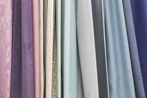 Multicolored textures of fabrics on the shelves of stores close-up Stock Photos