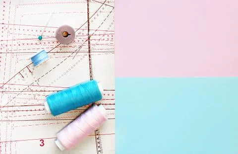 Multicolored thread coils on color background. Sewing supplies, pattern Stock Photos