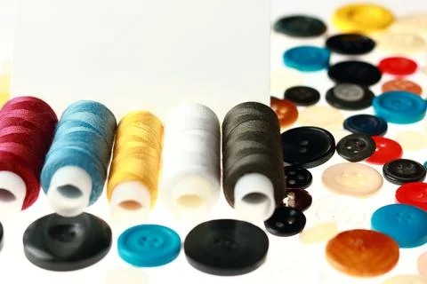 Multicolored threads and buttons for clothes. Stock Photos