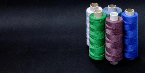 Multicolored threads on a black background 写真素材