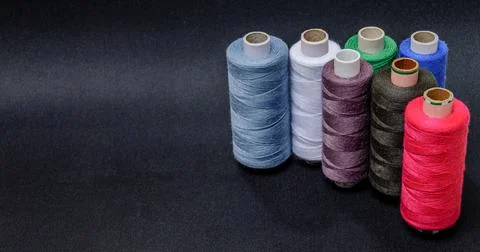 Multicolored threads on a black background Stock Photos