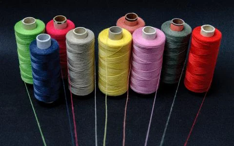 Multicolored threads emitting rays on a black background Stock Photos