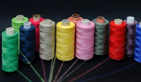 Multicolored threads emitting rays on a black background Foto stock