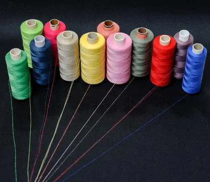 Multicolored threads emitting rays on a black background Stock Photos