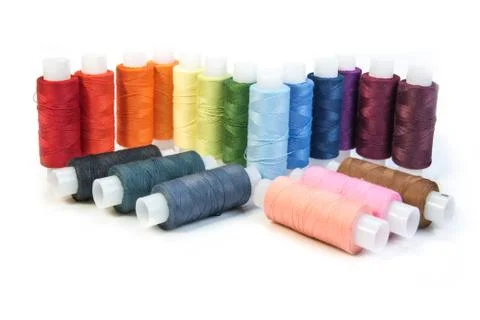 Multicolored threads for sewing on spools Stock Photos