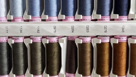 Multicolored threads on the shelves in the store, sewing kit. Specialized sewing Vídeo Stock 250113308