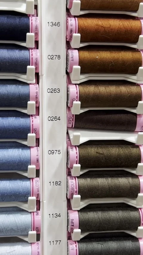 Multicolored threads on the shelves in the store, sewing kit. Specialized sewing Stock-Footage 250386892