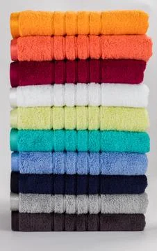 Multicolored towels on a white background Stock Photos