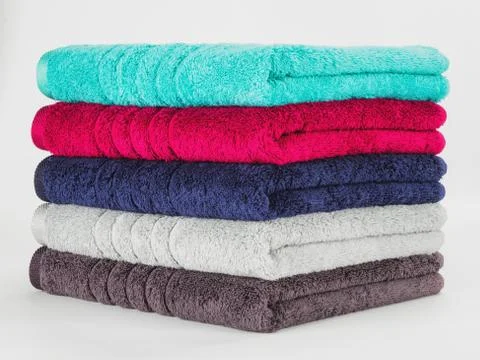 Multicolored towels on a white background Stock Photos